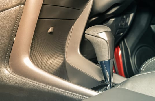 Gray Automatic Gear Handle in Car Interior on Right Frame with Front Seat in Vintage Tone