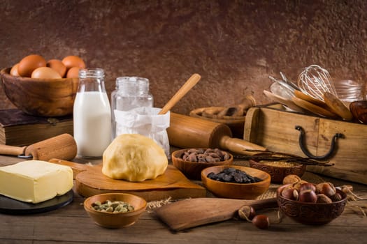 Assortment of baking ingredients and kitchen utensils in vintage wooden style. Christmas baking concept.