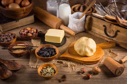 Assortment of baking ingredients and kitchen utensils in vintage wooden style. Christmas baking concept.