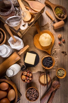 Assortment of baking ingredients and kitchen utensils in vintage wooden style. Christmas baking concept.