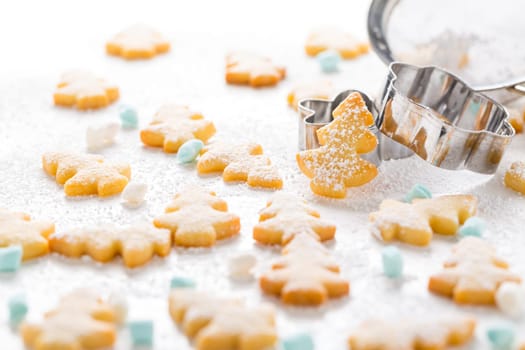 Homemade Christmas cookies in Christmas tree shape on marble background