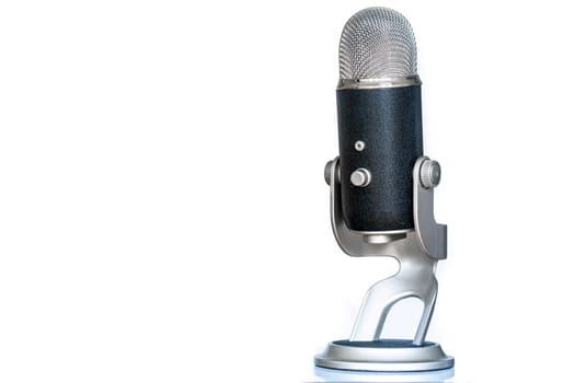 Microphone with classic and vintage look standing up. Used for podcasting or other voice recording. Isolated on white background