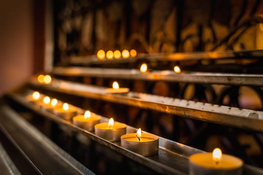 Light a candle for someone. Candles are lit for prayer intentions in The Cathedral Basilica of St James the Apostle in Szczecin, Poland