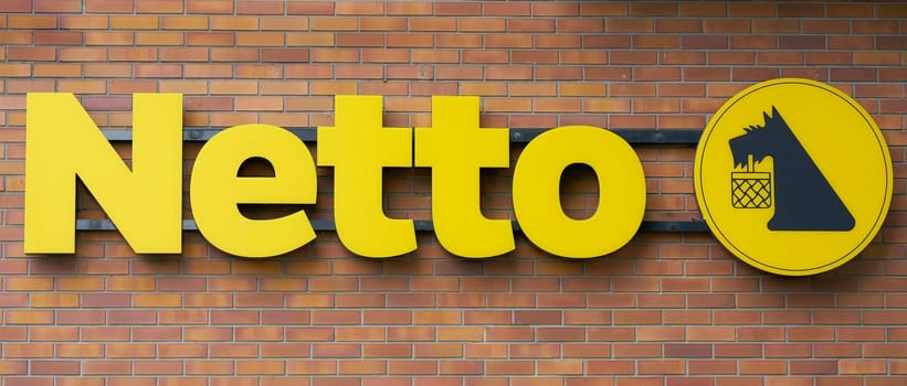 Illuminated advertising of a Netto food market in Swinoujscie in Poland