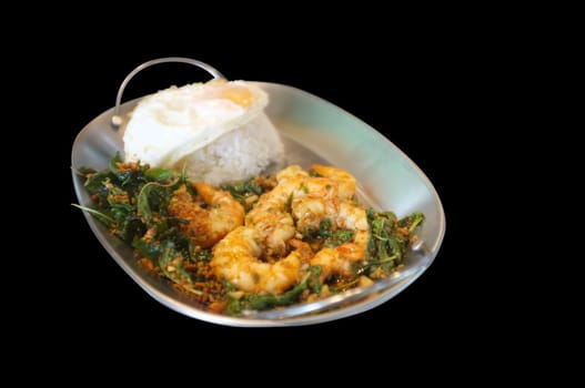 Stirred-fry shrimps or prawns with basil leaves, fried egg over rice. Thai food