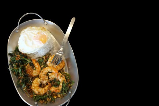 Stirred-fry shrimps or prawns with basil leaves, fried egg over rice. Thai food