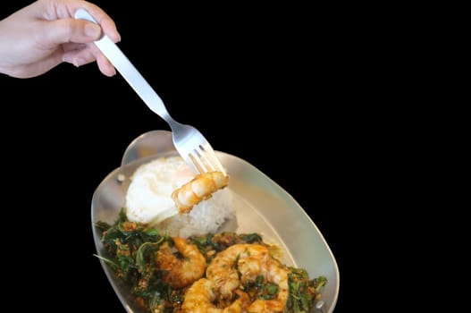 Stirred-fry shrimps or prawns with basil leaves, fried egg over rice. Thai food