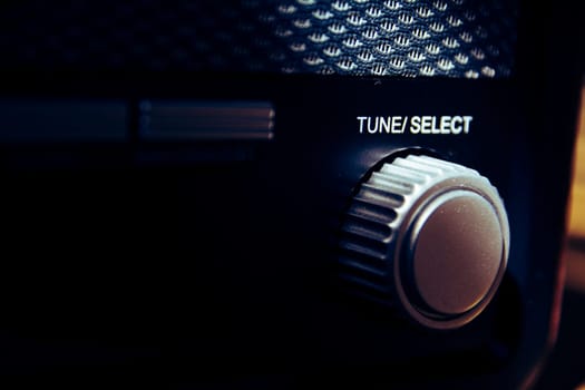 Tune Select button on a vintage and retro analogue radio. Finetuning the radio station. Creative and vintage processing. Selective focus.