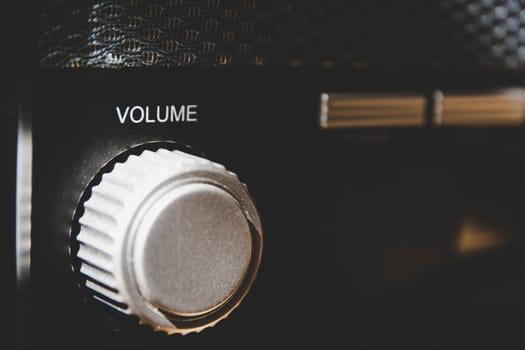 Volume wheel on an old and vintage analog radio. Creative processing for retro looks. Selective focus.