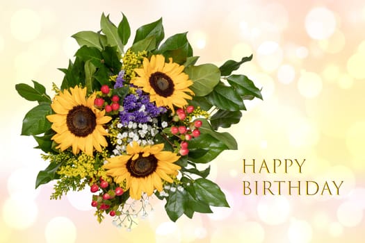 Happy birthday card design with a gorgeous blooming bouquet of sunflowers on a bright abstract delicate pastel blurred background.