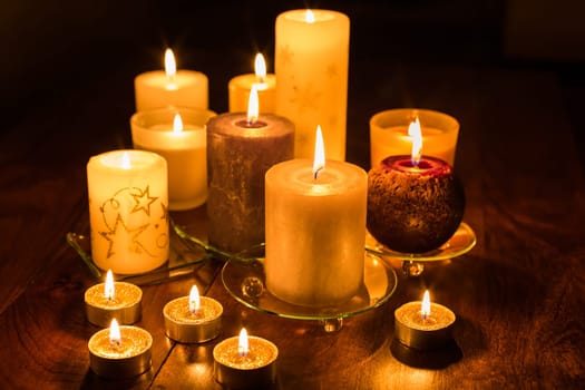Candles on wooden background. Candlelights for Christmas.