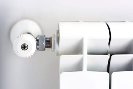 close-up view of the white knob that adjusts the temperature of the radiator. Heating and winter season