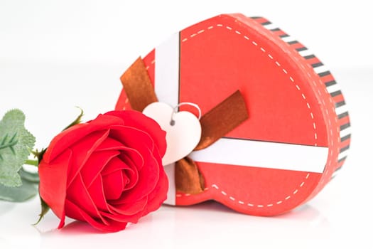 Close up red rose and heart-shaped box on white background, Wedding concept with roses and red heart-shaped box