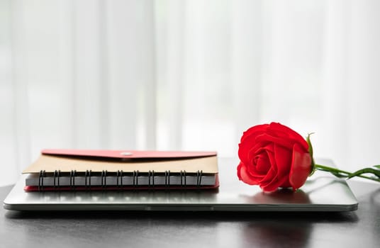 Red rose and the laptop on deck, Valentine concept