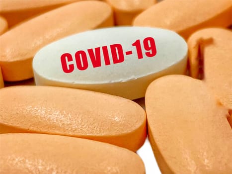 COVID-19 text and pills on white  background. Covid-19 or Coronavirus Concept