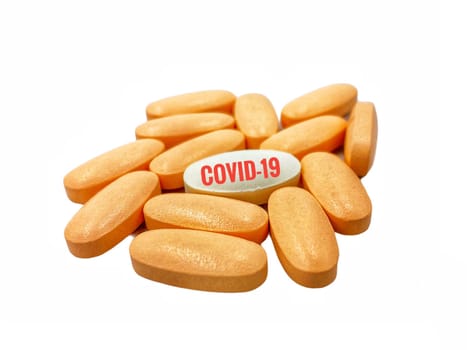 COVID-19 text and pills on white  background. Covid-19 or Coronavirus Concept