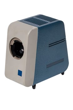 Vintage projector. Close-up of a old blue gray projector for viewing slides and filmstripes isolated on a white background. Entertainment last century to look holiday pictures on a projection screen. Macro.