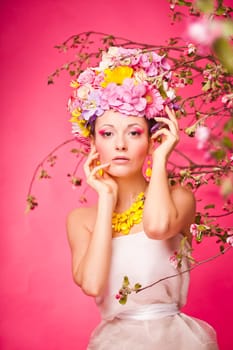Woman standing under apple tree flowers. Plastic jewerly