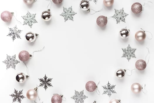 White and silver Christmas ornaments and gift on white background top view. Christmas and Holidays greeting card, frame, banner. New Year. Noel. Winter xmas holiday theme. Flat lay