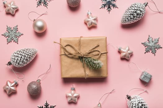 Christmas greeting card. Gift boxes and Christmas decorations layout on pink background, top view. Flat lay.Christmas and Holidays greeting card.