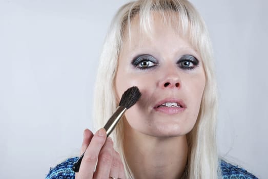 Woman applying makeup