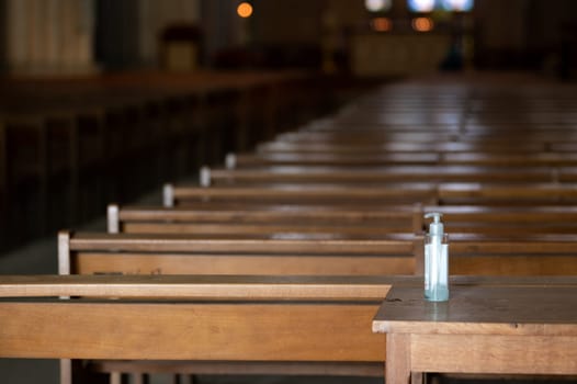 Bottle of hydro-alcoholic gel deposited at the entrance of a church during the Coronavirus Covid 19 pandemic.