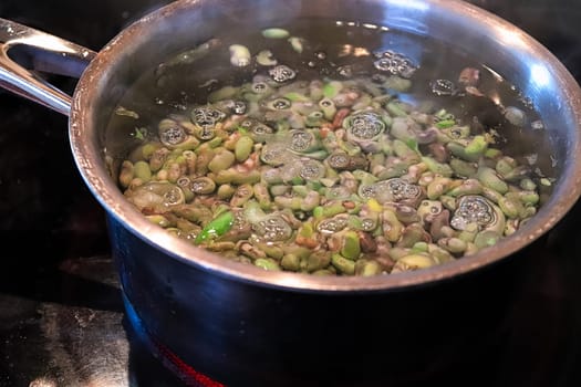 A pot of green beans being blanched in a pot of water.
