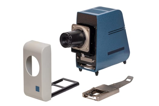 Vintage projector. Close-up of a old blue gray projector for viewing slides and filmstripes isolated on a white background. The projector consists of a light source lamp, lens, cover and the slide changer. Macro.