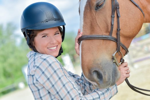 a happy female rider and her horse