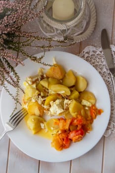 Boiled potatoes with vegetables on white plate. Flat view