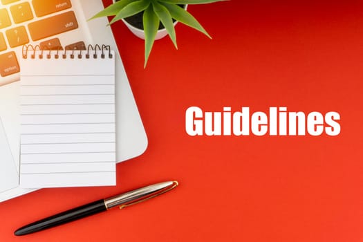 GUIDELINES text with notepad, laptop, fountain pen and decorative plant on red background. Business and Copy Space Concept