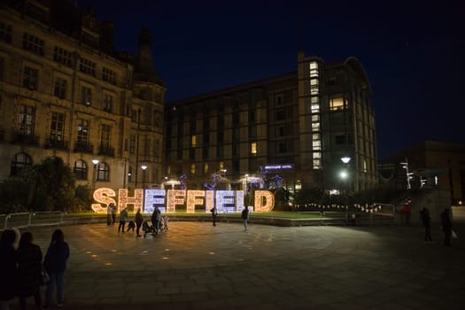 Sheffield, United Kingdom, 27th November, 2020: wide angle image of the peace gardens in sheffield city center with people enjoying christmas lights