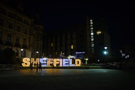 Sheffield, United Kingdom, 27th November, 2020: A few people admire the sheffield christmas lights during the 2nd Covid lock down. Peace garden area