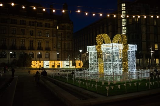 Sheffield, United Kingdom, 27th November, 2020: Lit up in fairy lights, the word sheffield, a large gift and light bulbs. Christmas light display 2020