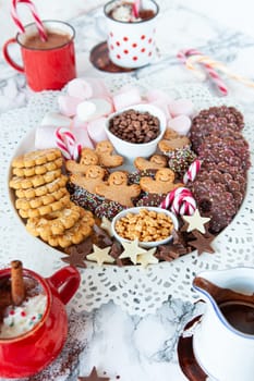 Hot chocolate with a plate of toppings and cookies