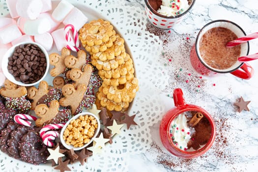 Hot chocolate with a plate of toppings and cookies