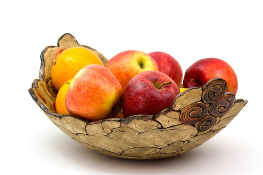 fresh fruits in a clay bowl - oranges and apples