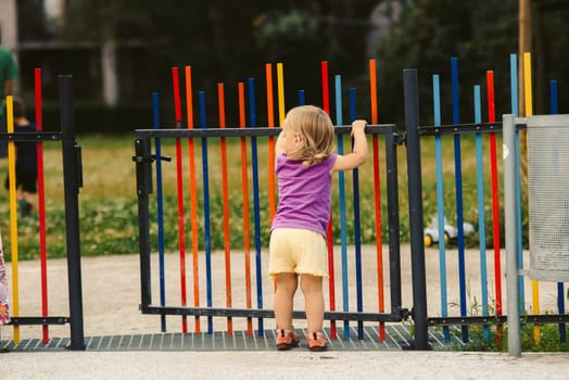 the blonde haired girl runs away from the playground