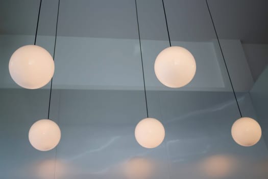 Lamp hanging in a dark room, stock photo
