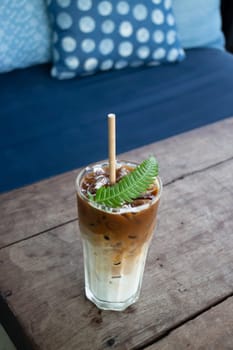 Coffee glass decorated with fern leaf, stock photo