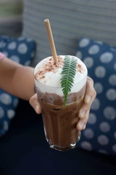 Coffee glass decorated with fern leaf, stock photo
