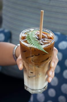 Coffee glass decorated with fern leaf, stock photo