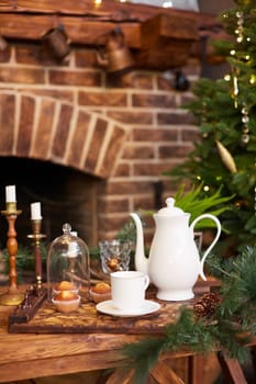 Home Christmas decoration interior late in night with light on xmas tree and fireplace.