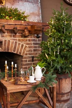Home Christmas decoration interior late in night with light on xmas tree and fireplace.