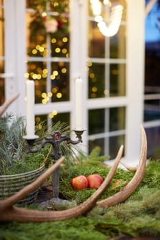 Home Christmas decoration interior late in night with light on xmas tree and gifts.