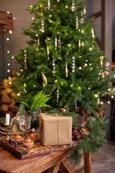 Home Christmas decoration interior late in night with light on xmas tree and gifts.
