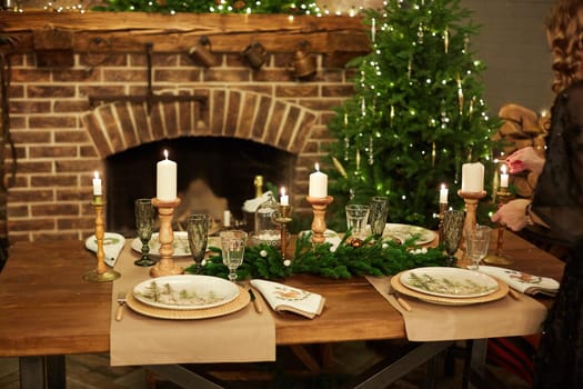 Home Christmas decoration interior late in night with light on xmas tree and fireplace.