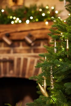 Home Christmas decoration interior late in night with light on xmas tree and fireplace.