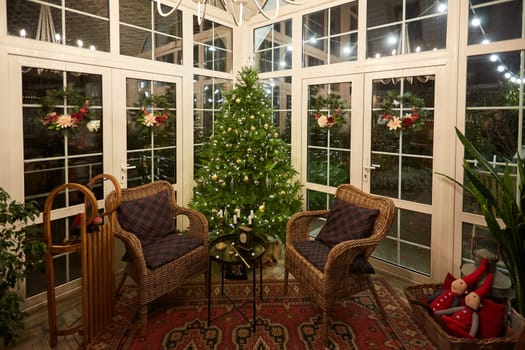 Home Christmas decoration interior late in night with light on xmas tree and gifts.