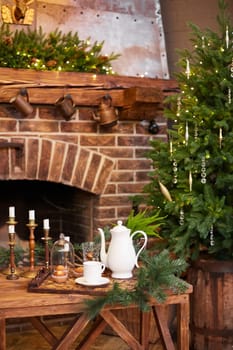 Home Christmas decoration interior late in night with light on xmas tree and fireplace.